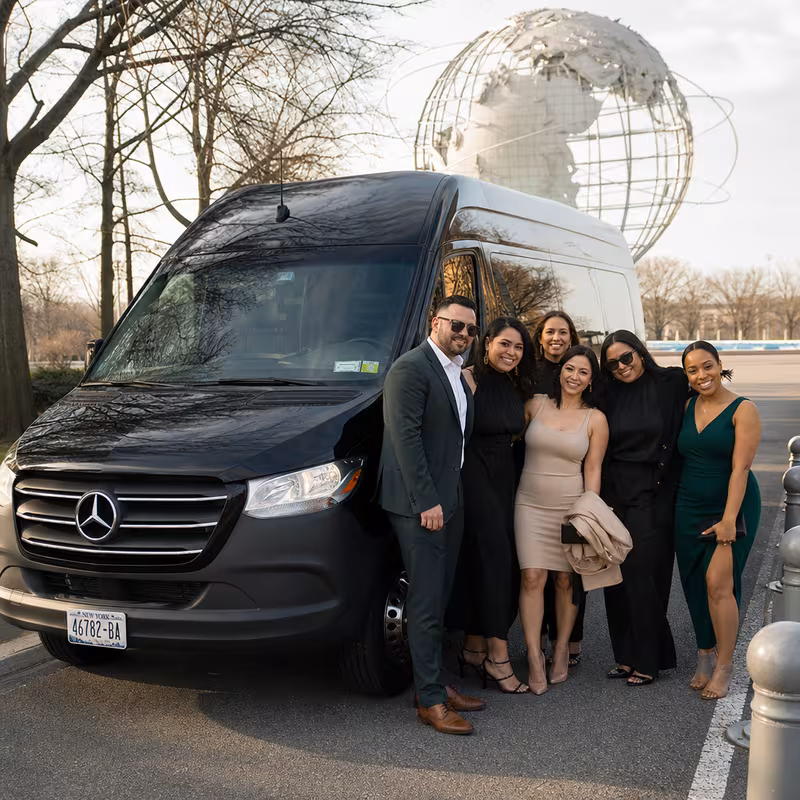 Group beside a Mercedes Sprinter limo from the Queens fleet