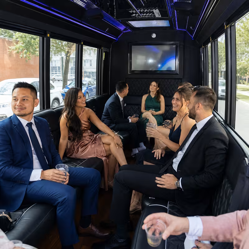 Wedding guests seated inside a Queens party bus