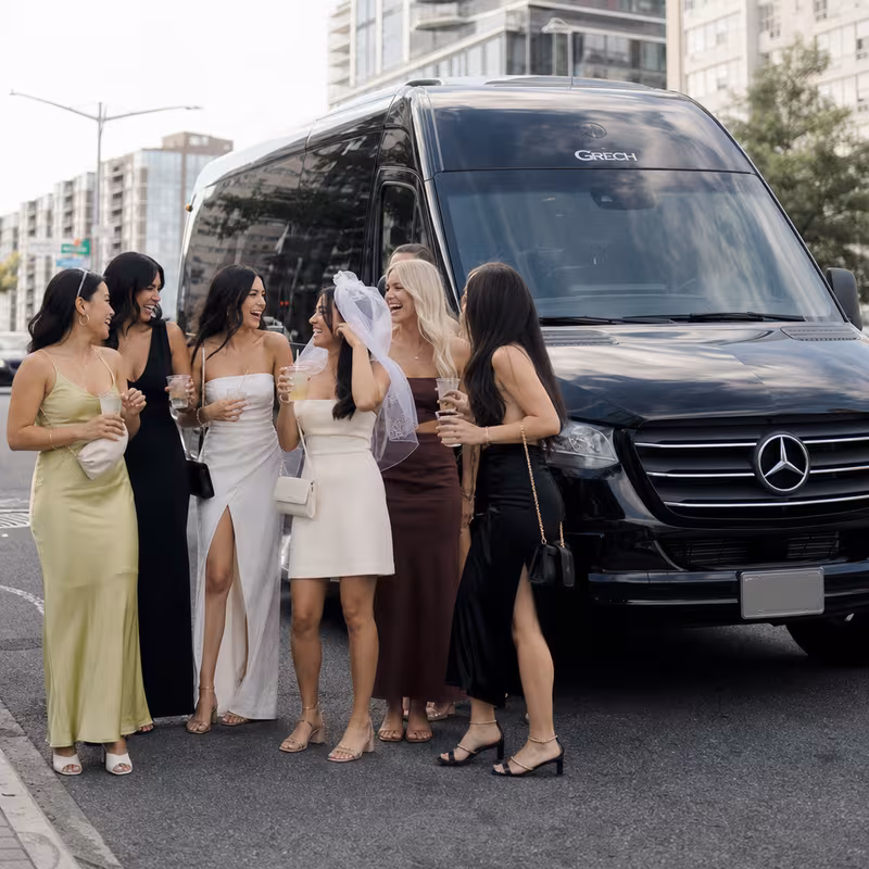 Group boarding a white charter bus for Bachelor & Bachelorette Transportation transportation in Queens