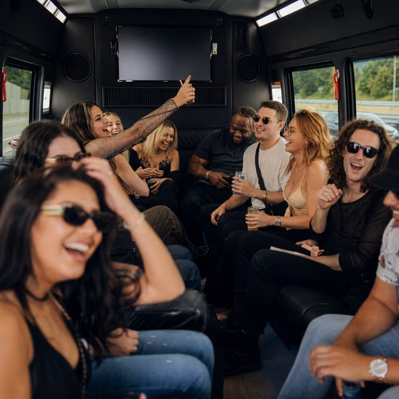 Group boarding a white charter bus for Concert Transportation transportation in Queens