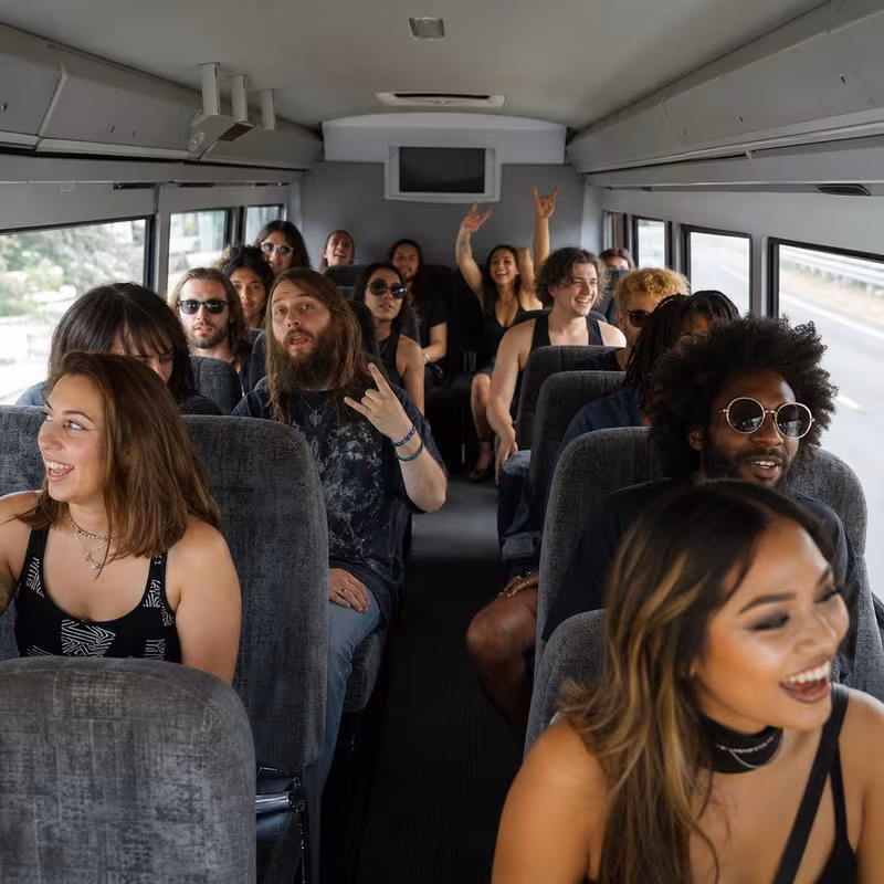 Party bus interior with wraparound leather seating and LED lighting in Queens
