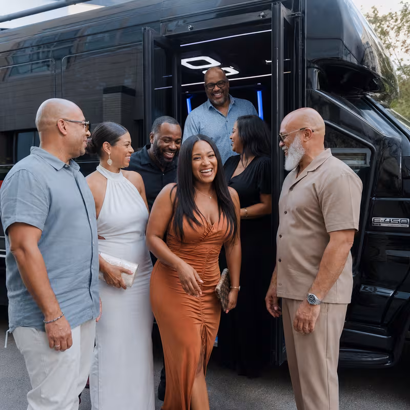 Passengers loading luggage while boarding an Queens group shuttle