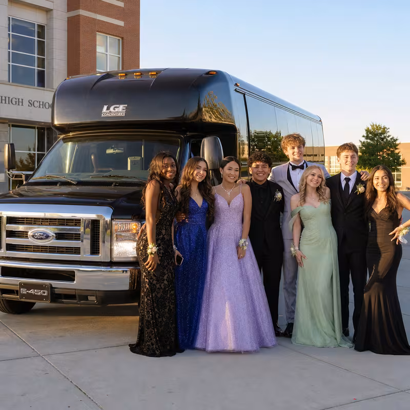 Group boarding a white charter bus for Prom & Homecoming Transportation transportation in Queens
