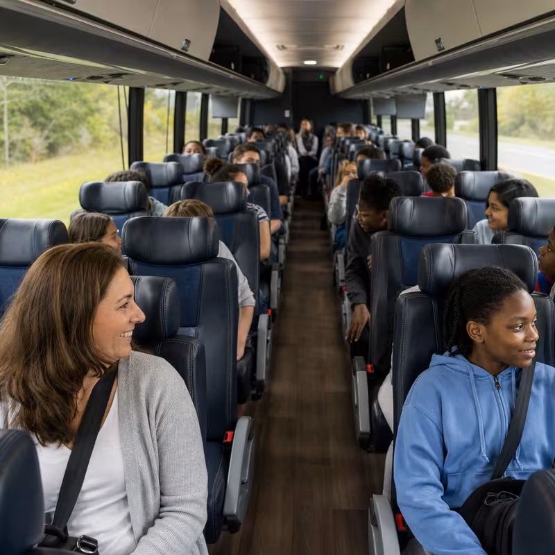 Group boarding a white charter bus for School Transportation transportation in Queens