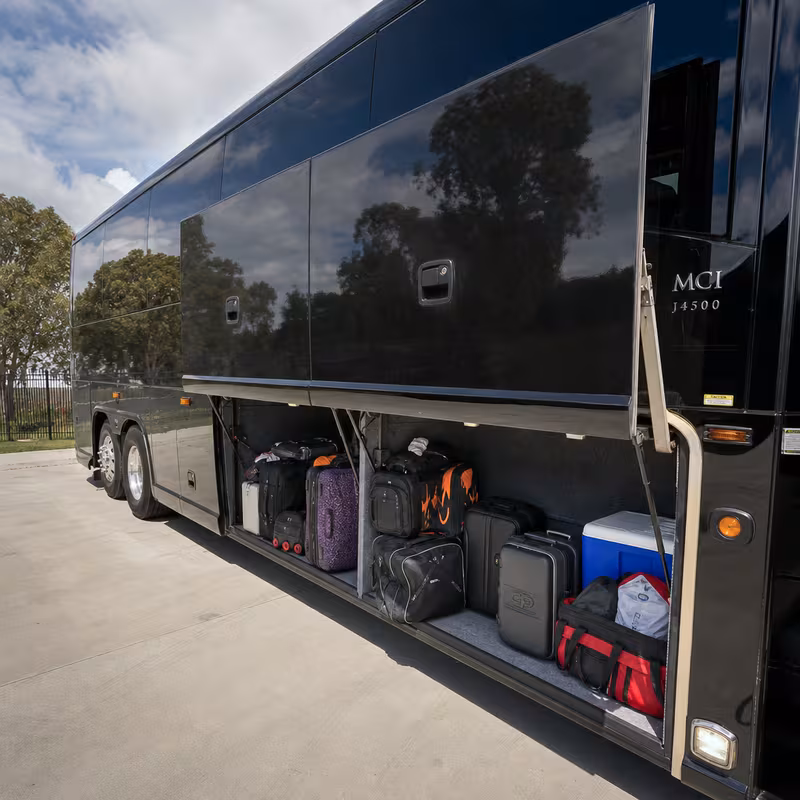 Party bus interior with wraparound leather seating and LED lighting in Queens