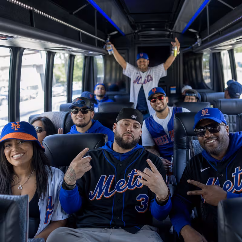 Group boarding a white charter bus for Sporting Event Transportation transportation in Queens