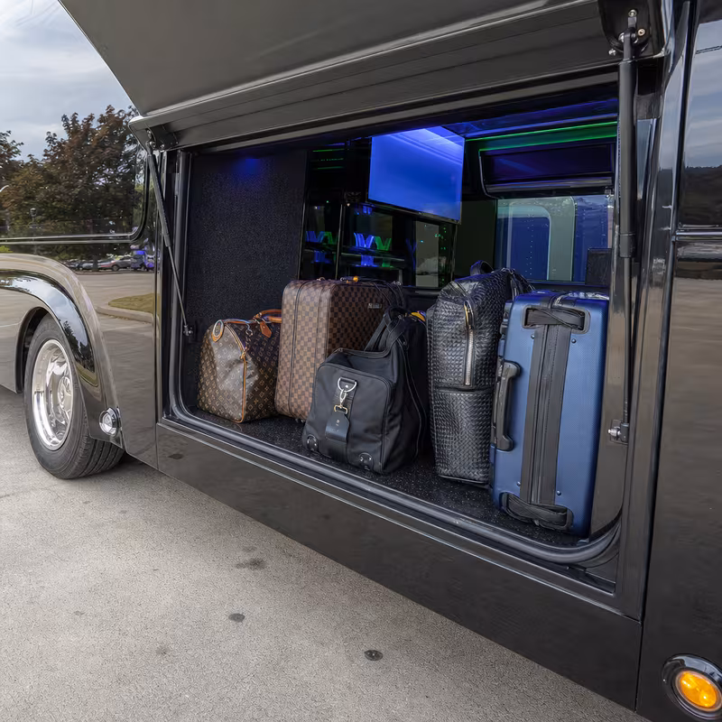 Party bus interior with wraparound leather seating and LED lighting in Queens