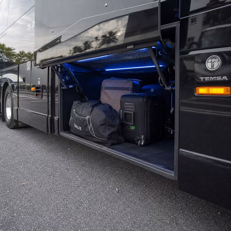 Party bus interior with wraparound leather seating and LED lighting in Queens